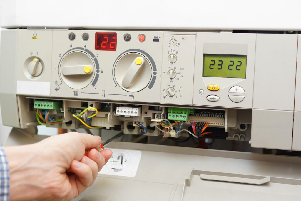 HVAC technician fixing a residential furnace