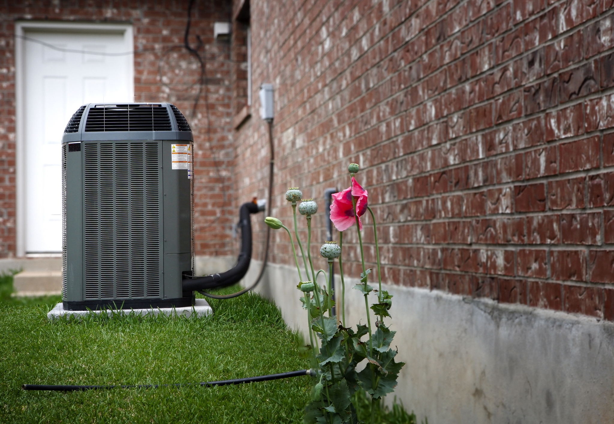 air conditioning unit outside brick home